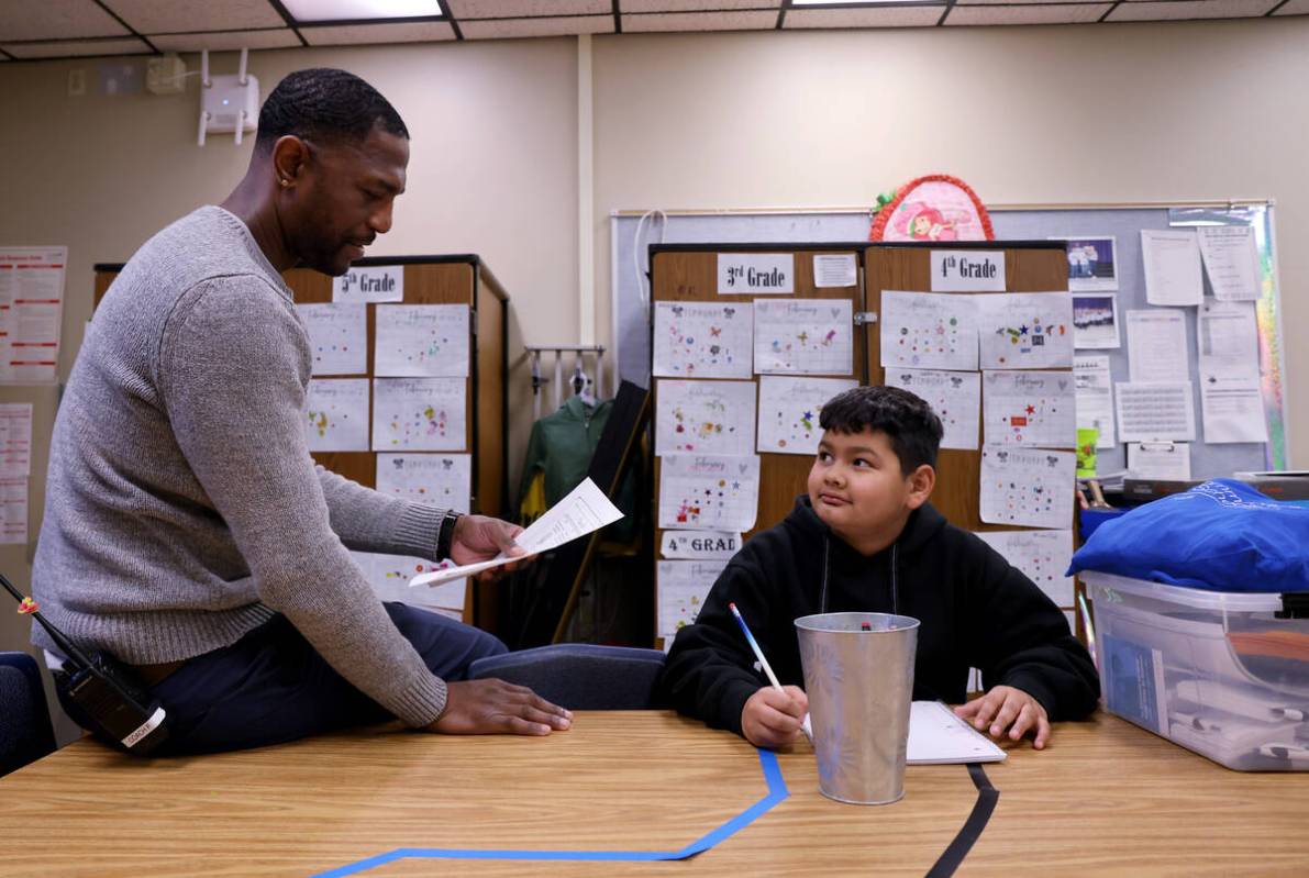 Communities In Schools of Southern Nevada Site Coordinator Raul Fention works with fifth grader ...