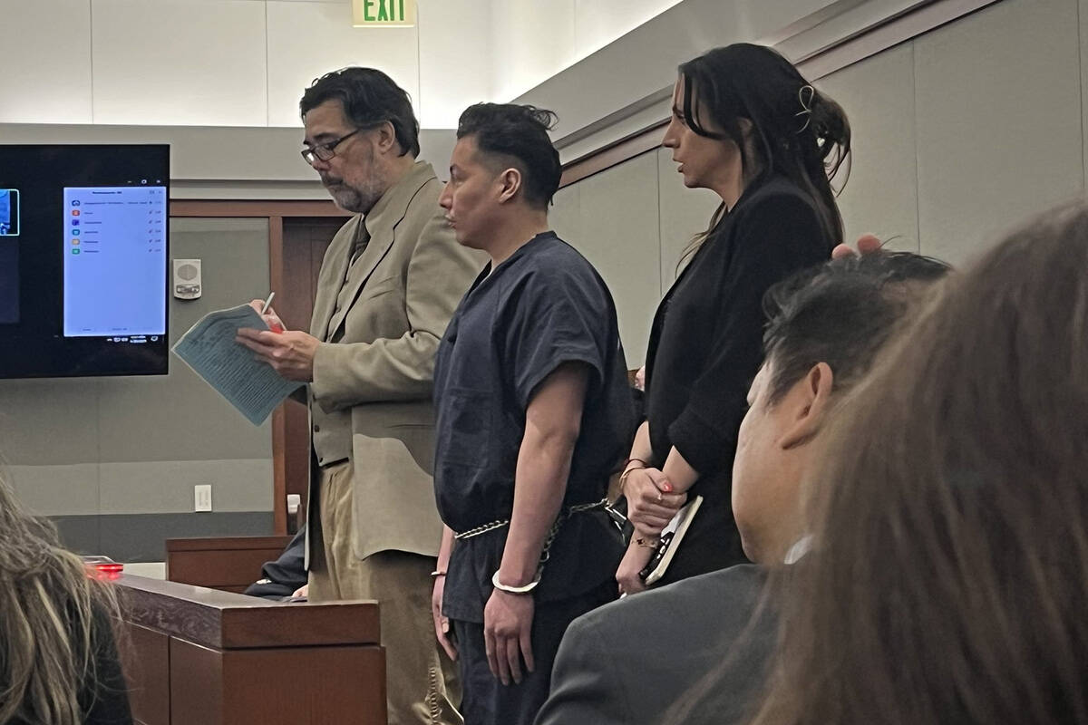 Yoni Barrios, center, with defense attorney Jeff Maningo, left, and an interpreter, appears in ...