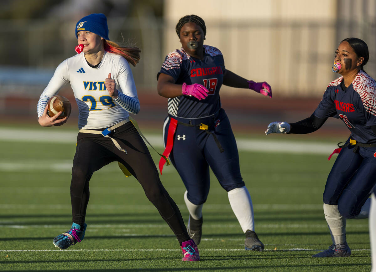 Sierra Vista quarterback Amaya Wusstig (29) evades Coronado linebacker Tielua Baptista (21) and ...