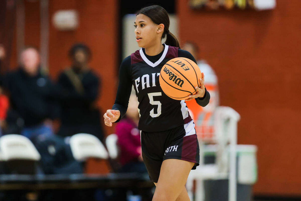 Faith Lutheran point guard Carly Young (5) dribbles the ball during a class 5A girls basketball ...