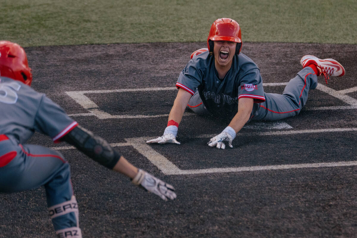 Arbor View’s Landon Blais (5) celebrates as he slides into home plate, scoring a run aga ...