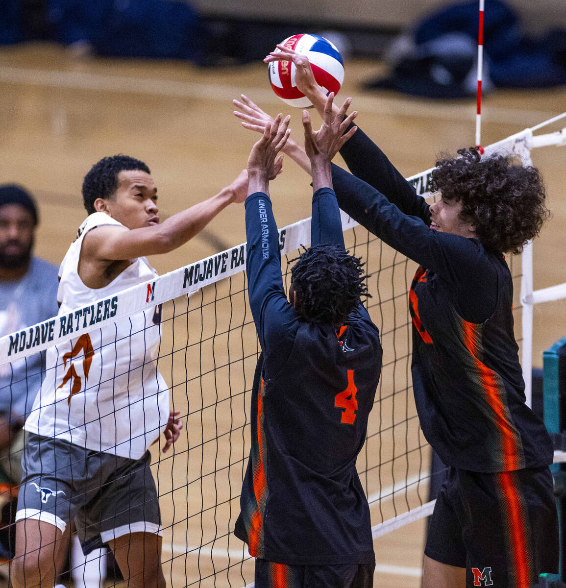 Legacy's Atlys Tapusoa (11) attempts to send the ball past Mojave's Jaion Richards (4) and Kale ...