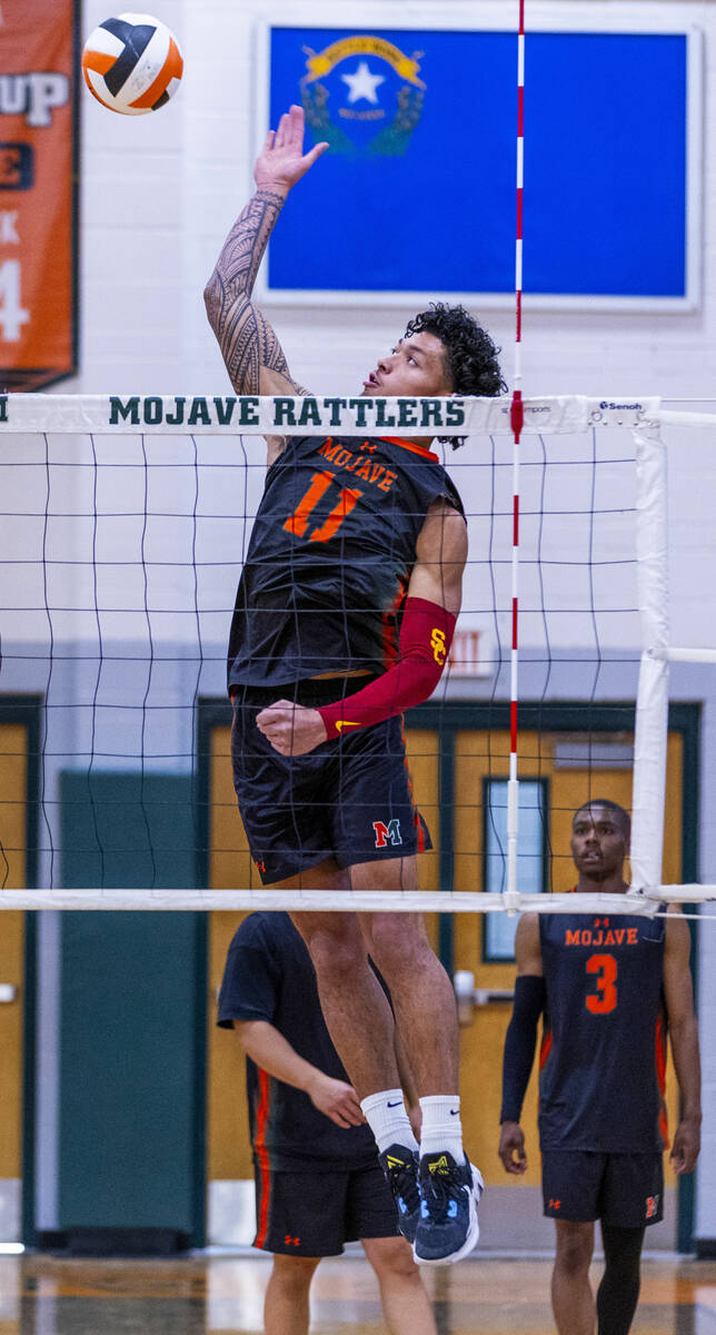 Mojave's Albert "AJ" Tuitele (11) spikes the ball as they face Legacy during their 4 ...