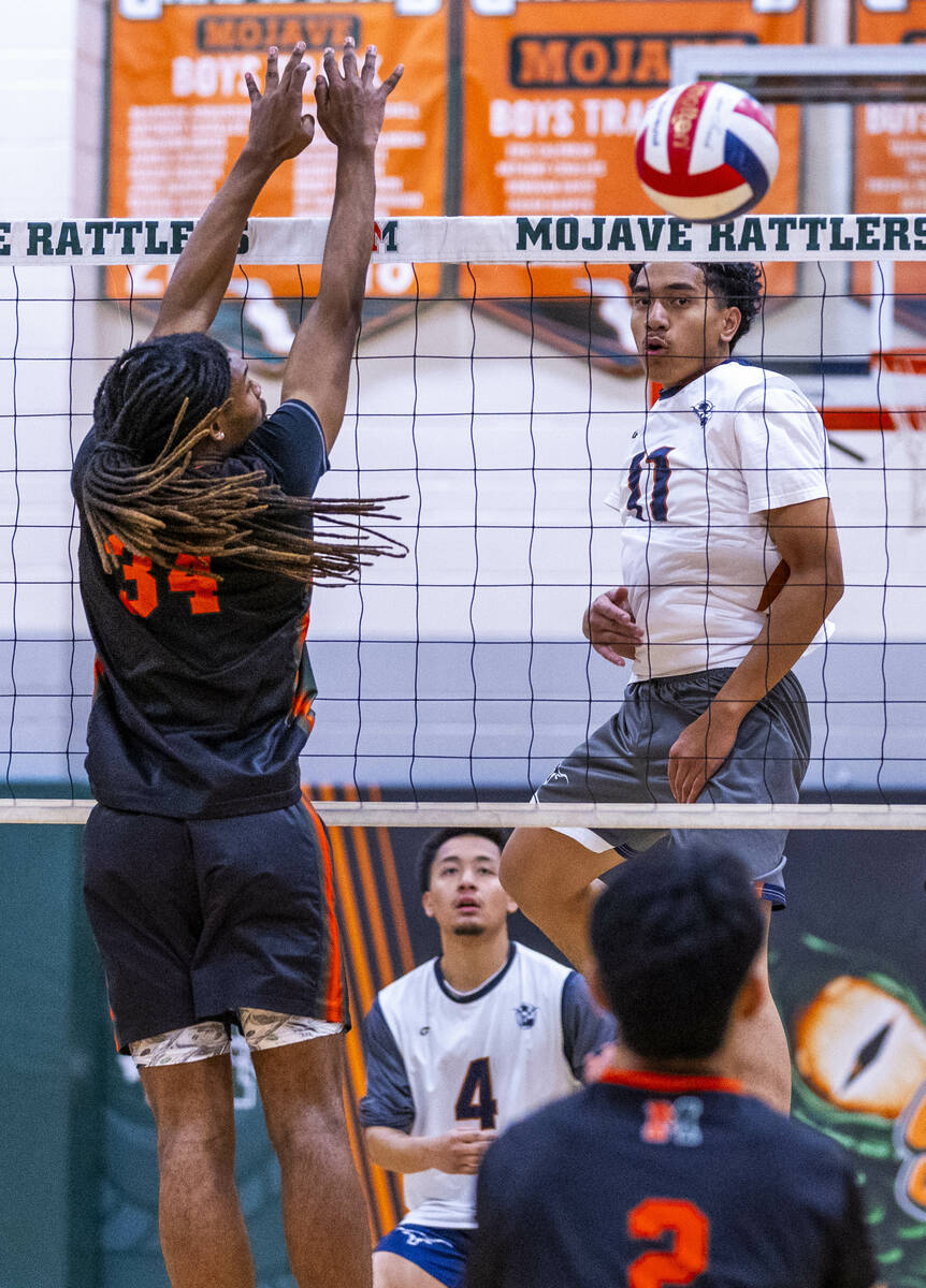 Legacy's Atlys Tapusoa (11) slaps the ball past the defense of Mojave's Quintrell McGee (34) du ...