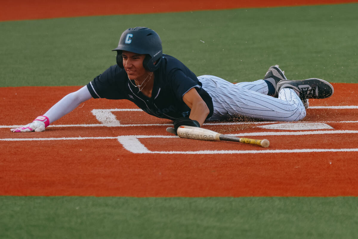 Centennial’s Chase Hurley (30) slides into home plate, earning the game-winning run for ...