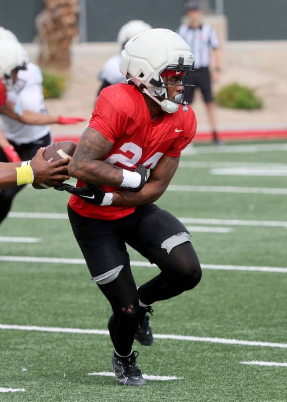UNLV running back Darrien Jones (24) takes a fake handoff during a team scrimmage at Bill 'Wild ...