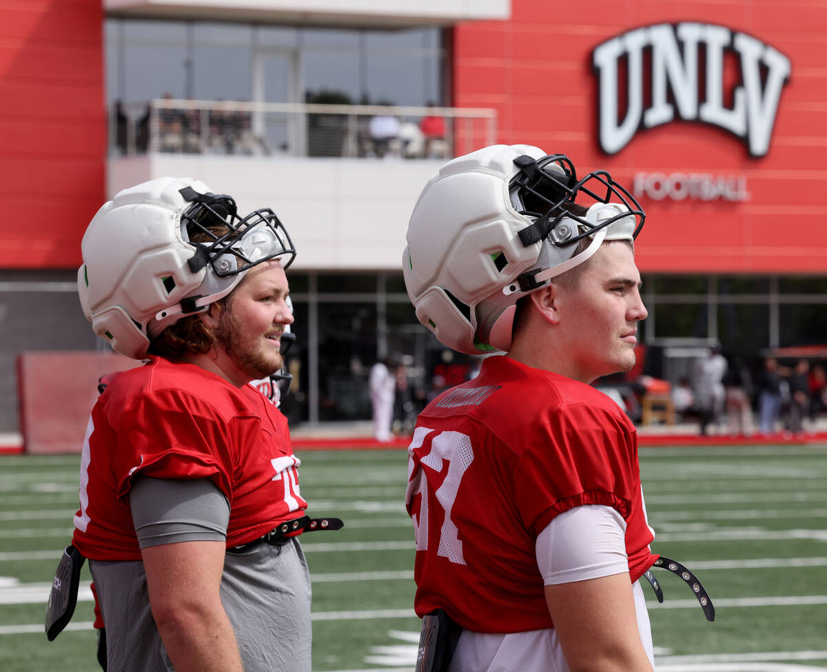 UNLV offensive lineman Austin Boyd (79) and offensive lineman Dyllan Drummond (57) watch during ...