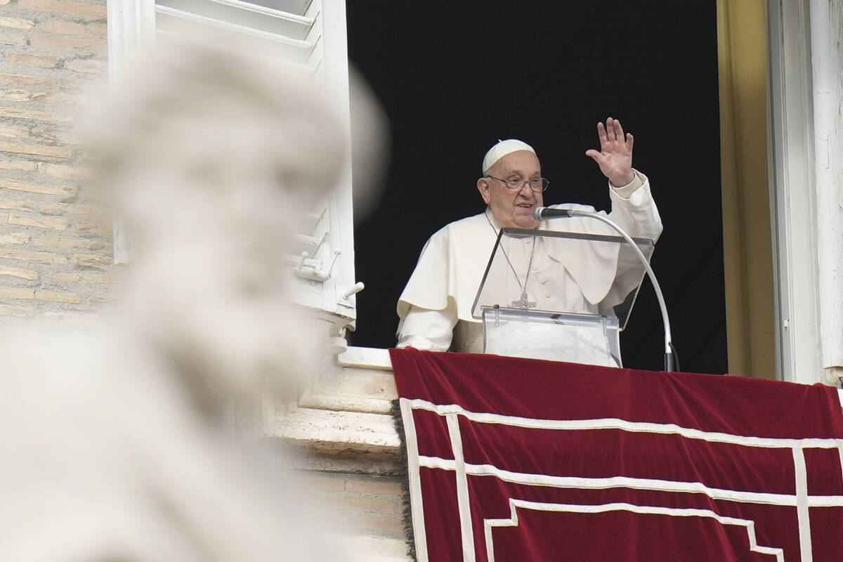 Pope Francis waves during the Angelus noon prayer on the occasion of the Epiphany day from the ...