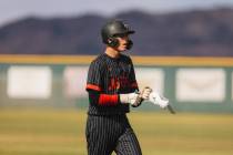 Las Vegas pitcher Hunter Iverson takes off his batting gear after making a run to second base d ...
