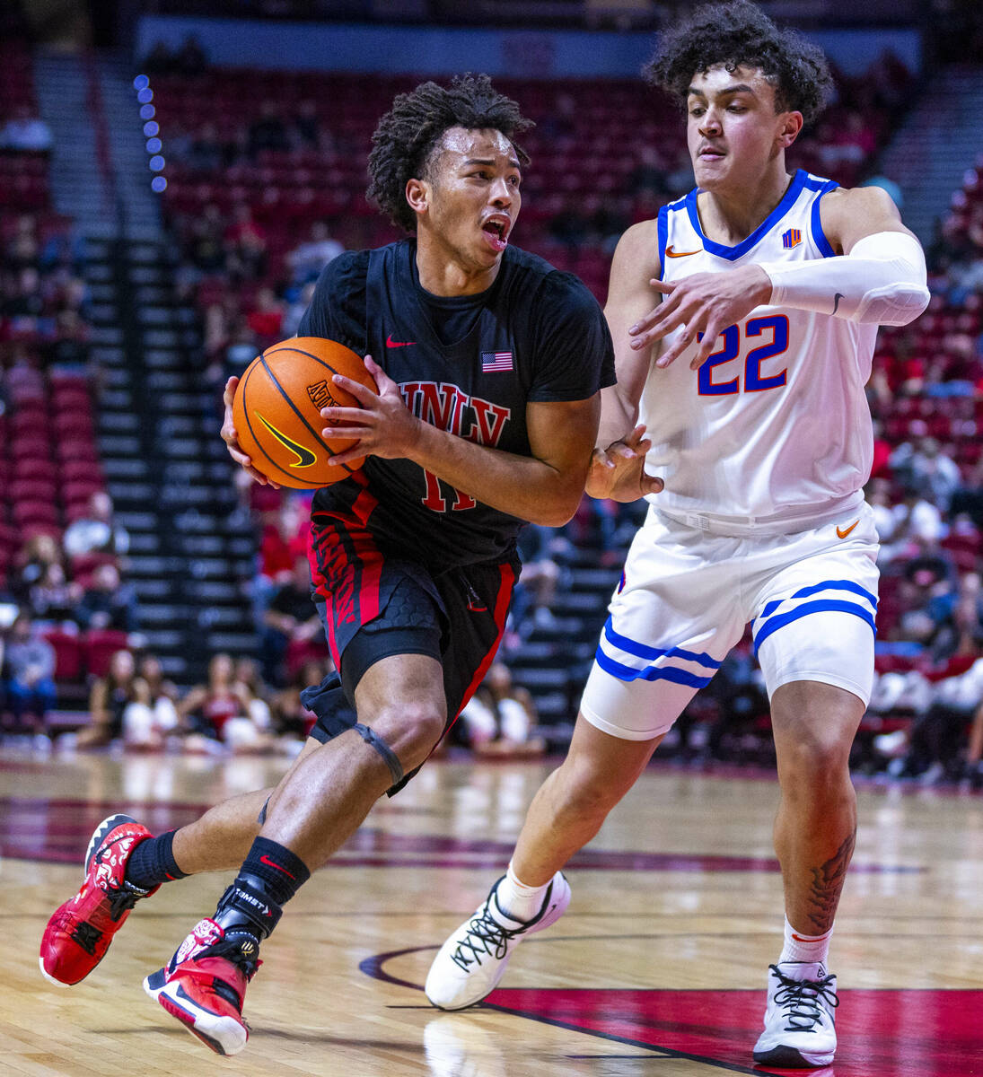 UNLV guard Dedan Thomas Jr. (11) drives the lane against Boise State Broncos forward Javan Buch ...