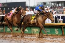 Sovereignty, right, ridden by Junior Alvarado, crosses the finish line to win the 151st running ...