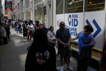 People line up to apply for Real ID at a Real ID Supercenter in downtown Chicago, Tuesday, May ...