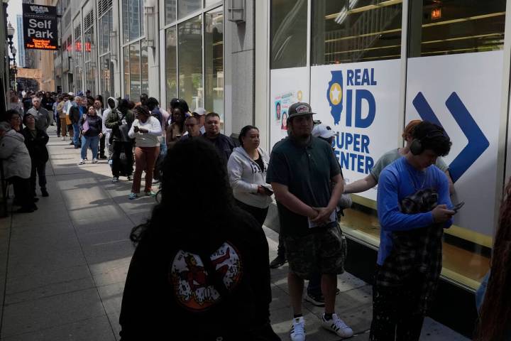 People line up to apply for Real ID at a Real ID Supercenter in downtown Chicago, Tuesday, May ...