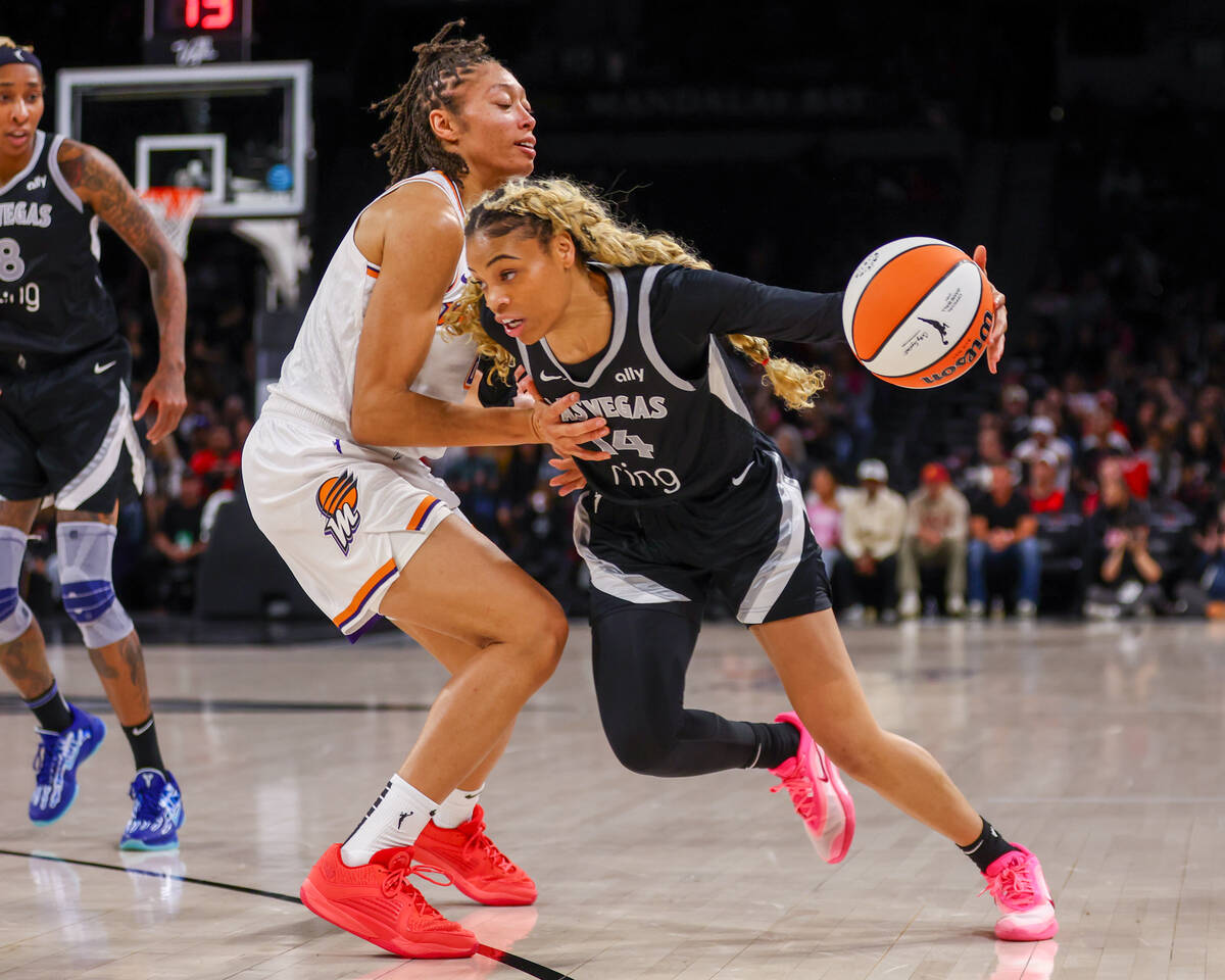 Aces guard Harmoni Turner (14) tries to dribble around Phoenix Mercury forward Alexis Prince (6 ...