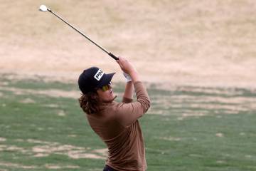Sky Pointe's Drake Harvey watches his approach shot on the first hole during the NIAA Class 4A ...