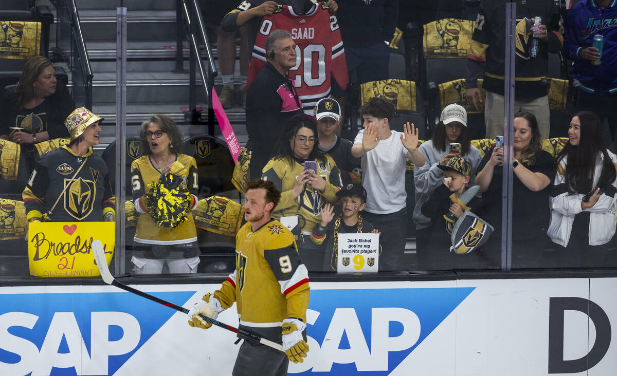 Golden Knights center Jack Eichel (9) skates past a young fan with a sign for him during the wa ...