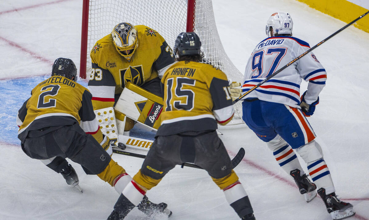 Golden Knights goaltender Adin Hill (33) saves a score attempt by Edmonton Oilers center Connor ...