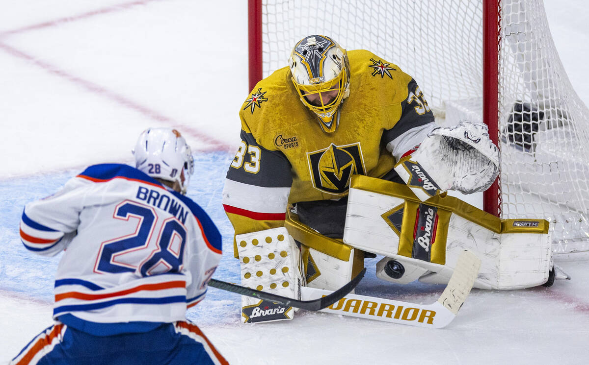 Golden Knights goaltender Adin Hill (33) deflects a shot away from Edmonton Oilers right wing C ...