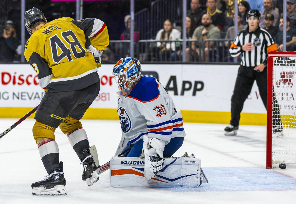 Golden Knights center Tomas Hertl (48) looks to a puck in the net past Edmonton Oilers goaltend ...