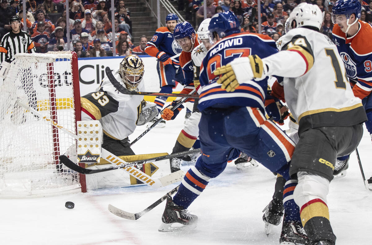 Vegas Golden Knights goalie Adin Hill (33) makes a save against Edmonton Oilers' Connor McDavid ...