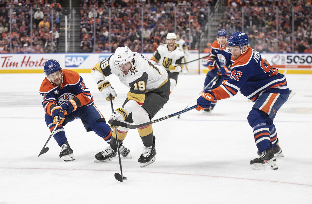Vegas Golden Knights' Reilly Smith (19) skates between Edmonton Oilers' Viktor Arvidsson (33) a ...