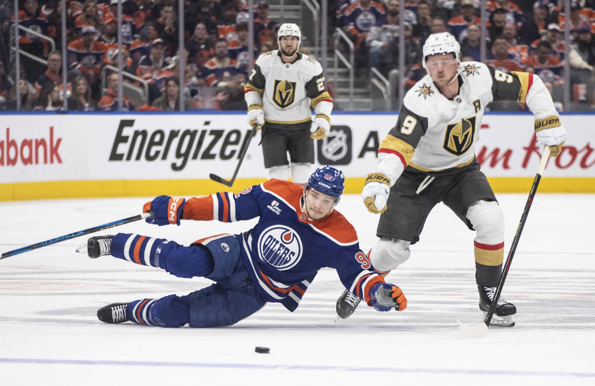 Vegas Golden Knights' Jack Eichel (9) and Edmonton Oilers' Vasily Podkolzin (92) battle for the ...