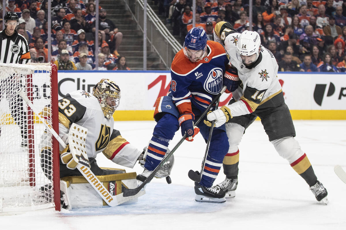 Vegas Golden Knights goalie Adin Hill (33) makes a save against Edmonton Oilers' Zach Hyman (18 ...