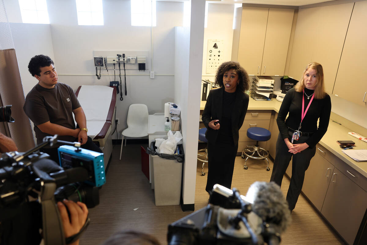 Director of Youth Programs and Family Services Tyra Mitchell, center, shows the medical clinic ...
