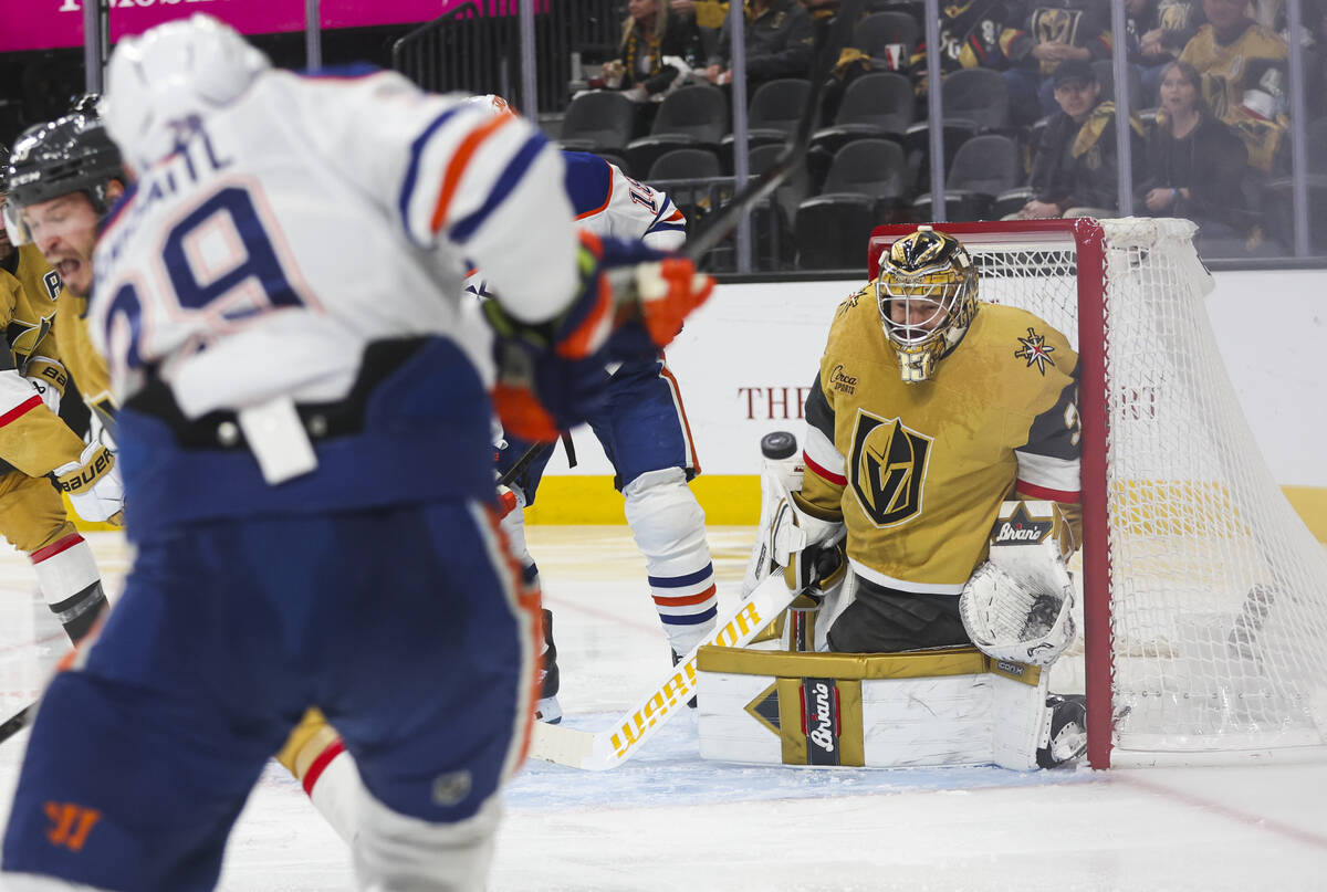 Golden Knights goaltender Adin Hill (33) moves to block a shot from Edmonton Oilers center Leon ...