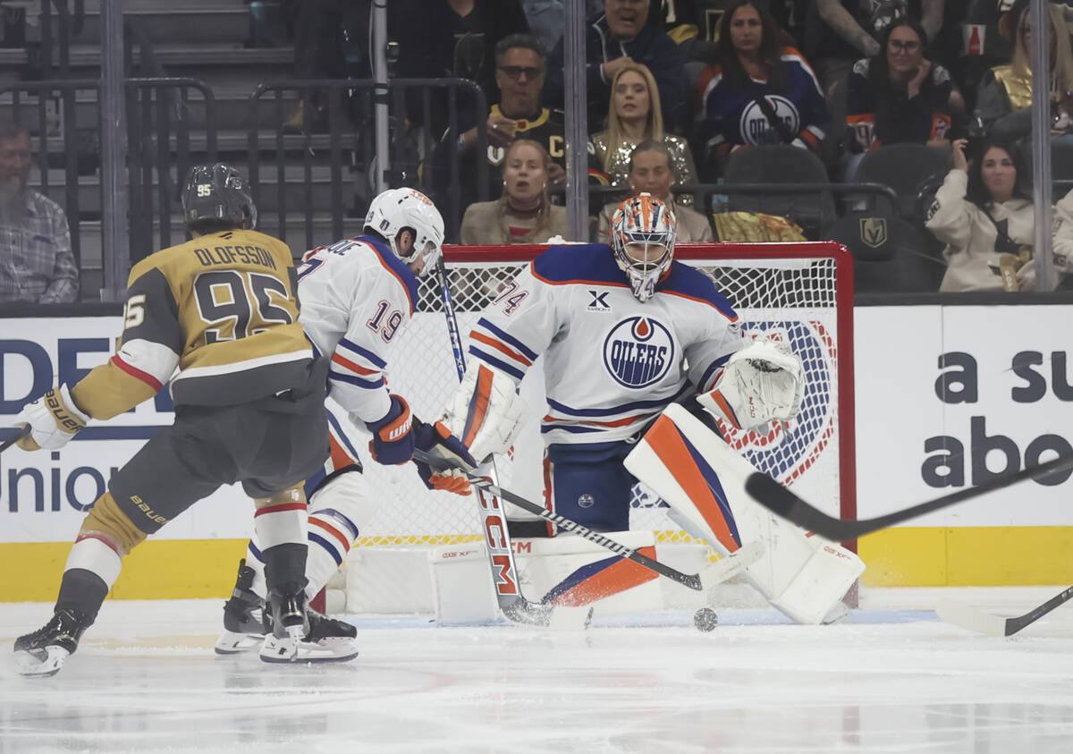 Edmonton Oilers center Adam Henrique (19) clears the puck after a shot was blocked by goaltende ...
