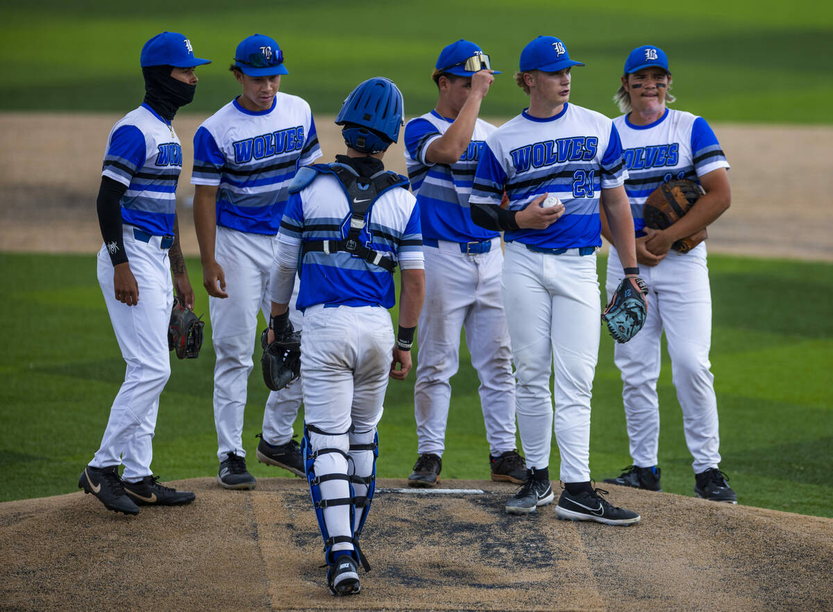 Basic infielders gather with pitcher Lincoln Evans (21) on the mound during a timeout against R ...