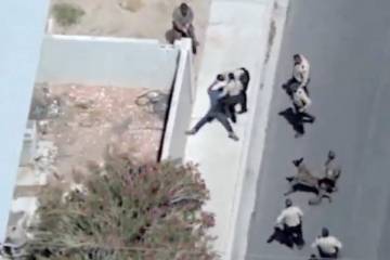 A man runs away from Las Vegas police officers after a high speed chase on Tuesday, May 13, 202 ...