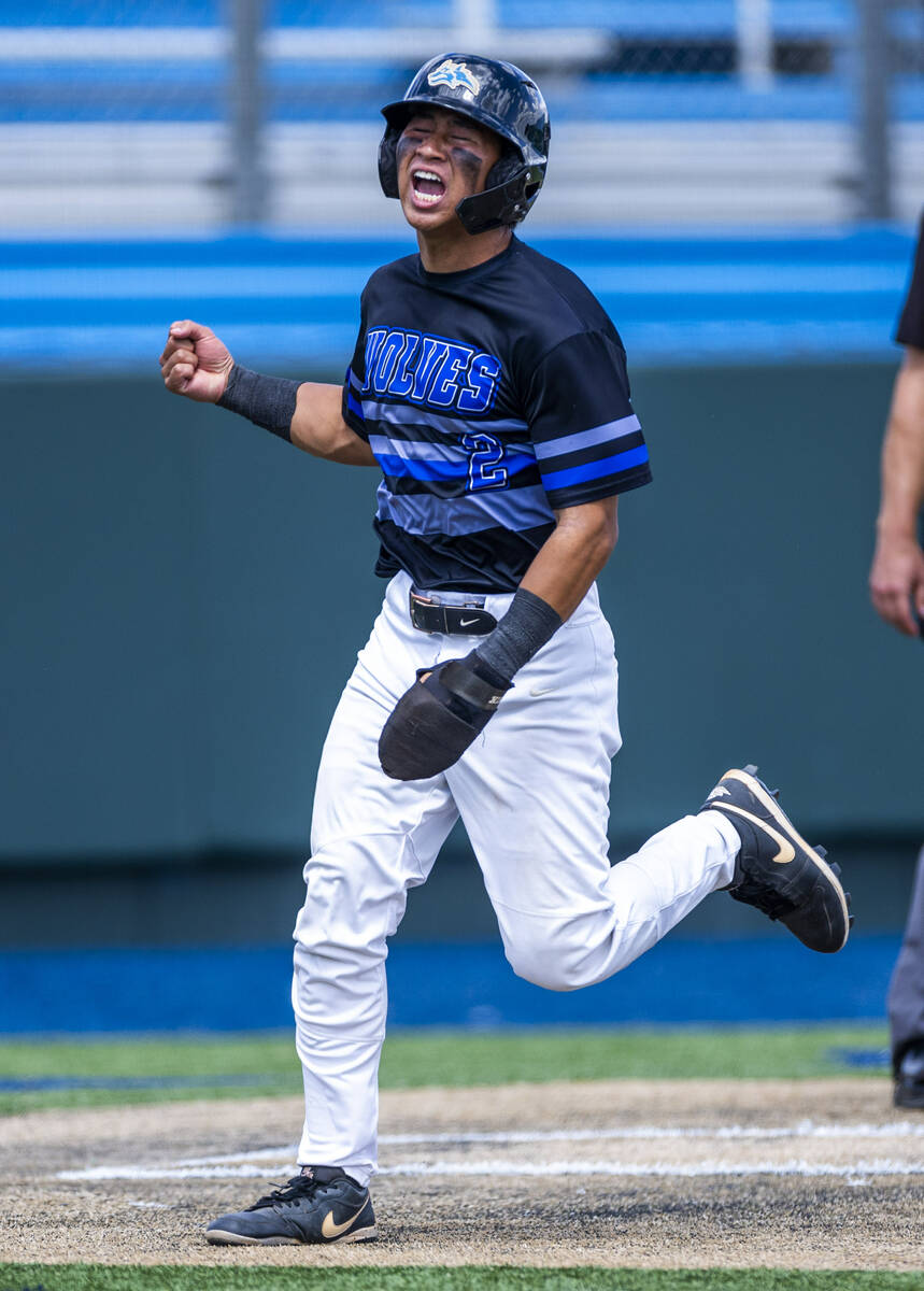 Basic runner Troy Southisene (2) celebrates a score against Faith Lutheran catcher Kade Gerboc- ...