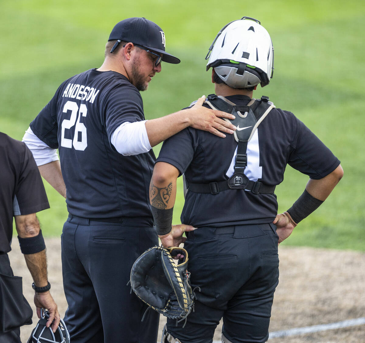 Faith Lutheran head coach David Anderson talks with catcher Kade Gerboc-Chun (4) against Reno d ...