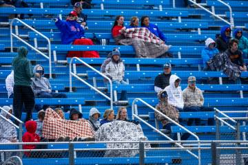 Fans are bundled up against the cold and rain as Basic battles Reno during the final of the 5A ...