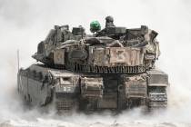 Israeli soldiers move tanks around staging area near the border with the Gaza Strip, in souther ...