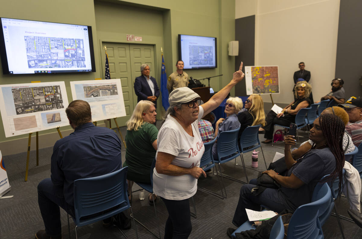 A woman, who left the meeting soon after, speaks during a community town hall to address housel ...