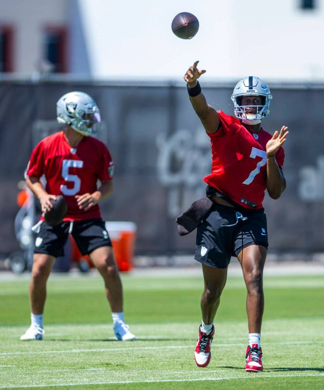 Raiders quarterback Geno Smith (7) gets off a pass with quarterback Cam Miller (5) looking for ...