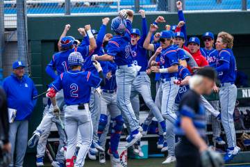 Reno players celebrate their first score of the game against Basic during the final of the 5A b ...