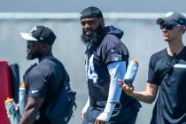 Raiders Christian Wilkins (94), center, looks on as teammates run a drill as he continues to re ...