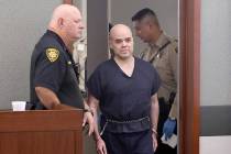 Marshal Randy Hawkes, left, watches at Robert Telles arrives in the courtroom for a hearing at ...