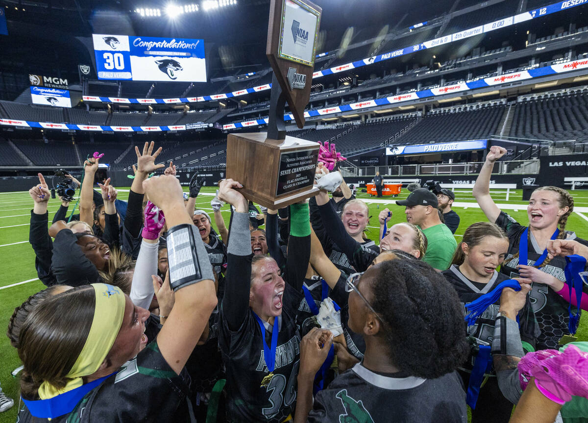 Palo Verde linebacker Madeline West (36) holds up the winning trophy with teammates after their ...