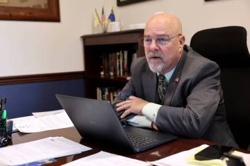 Sen. Ira Hansen, R-Sparks, talks to a staff member in his office in the Legislative Building in ...