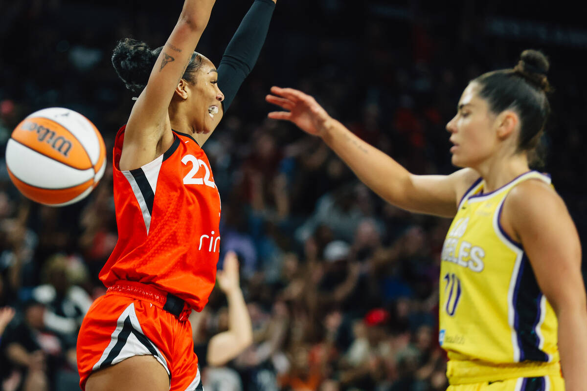 Aces center A'ja Wilson (22) celebrates as former teammate and Los Angeles Sparks guard Kelsey ...