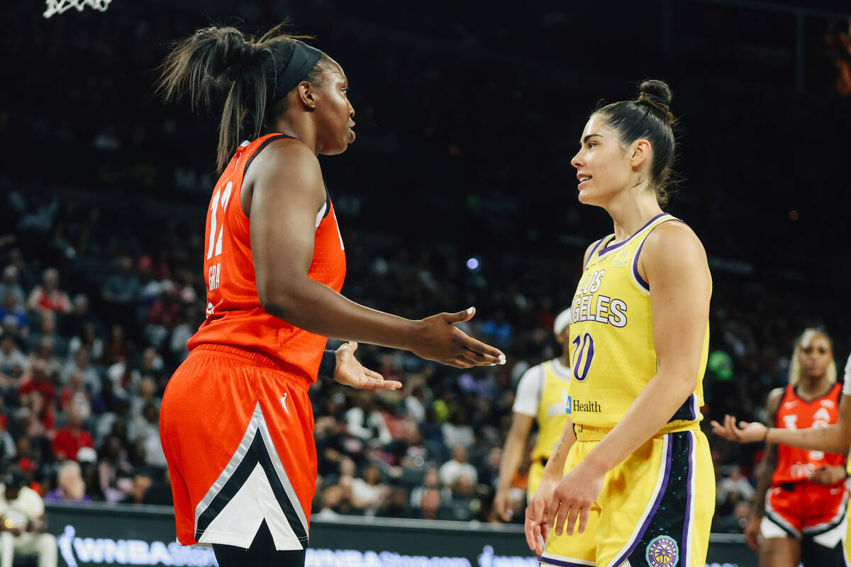 Aces guard Chelsea Gray (12) and former teammate and Los Angeles Sparks guard Kelsey Plum (10) ...