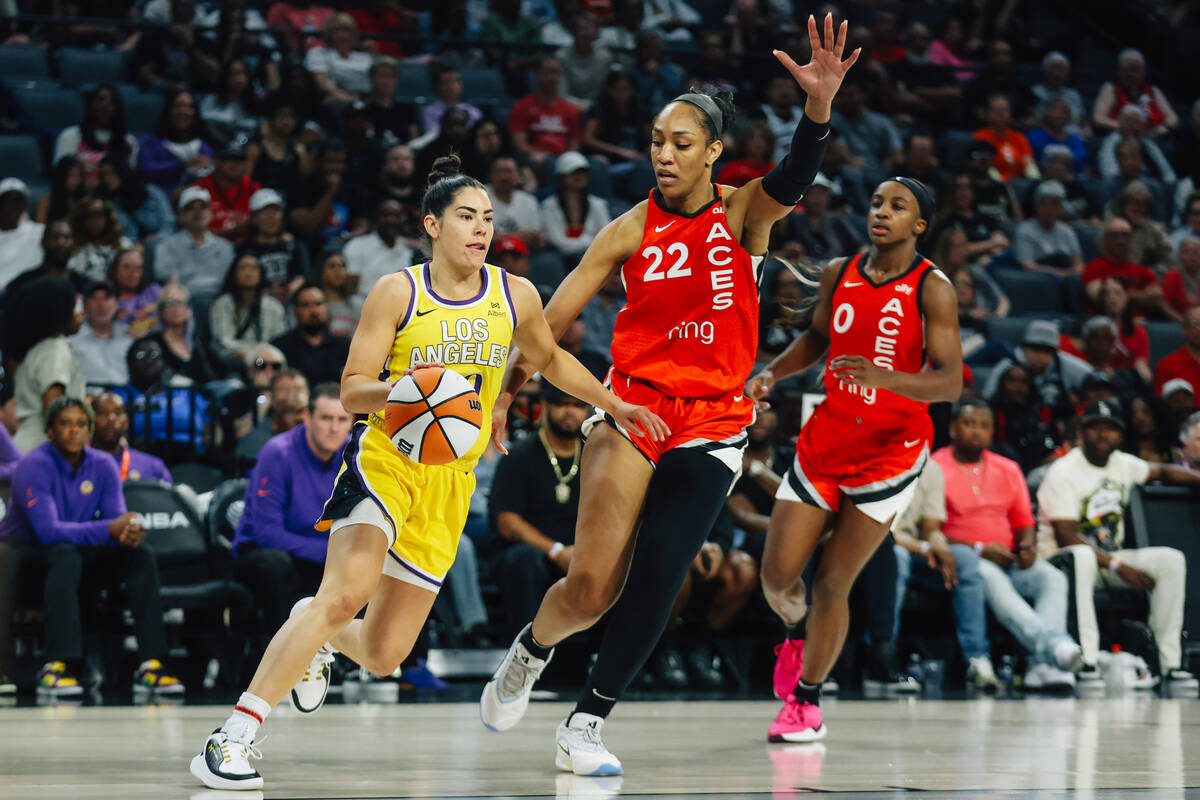Aces center A'ja Wilson (22) guards Los Angeles Sparks guard Kelsey Plum (10) during a WNBA bas ...