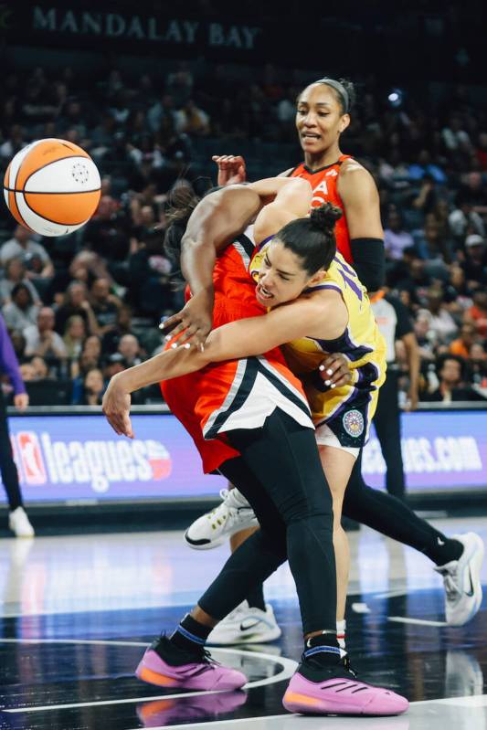 Los Angeles Sparks guard Kelsey Plum (10) fails to reach the ball over Aces guard Chelsea Gray ...