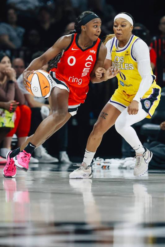 Aces guard Jackie Young (0) dribbles the ball past Los Angeles Sparks guard Odyssey Sims (0) du ...
