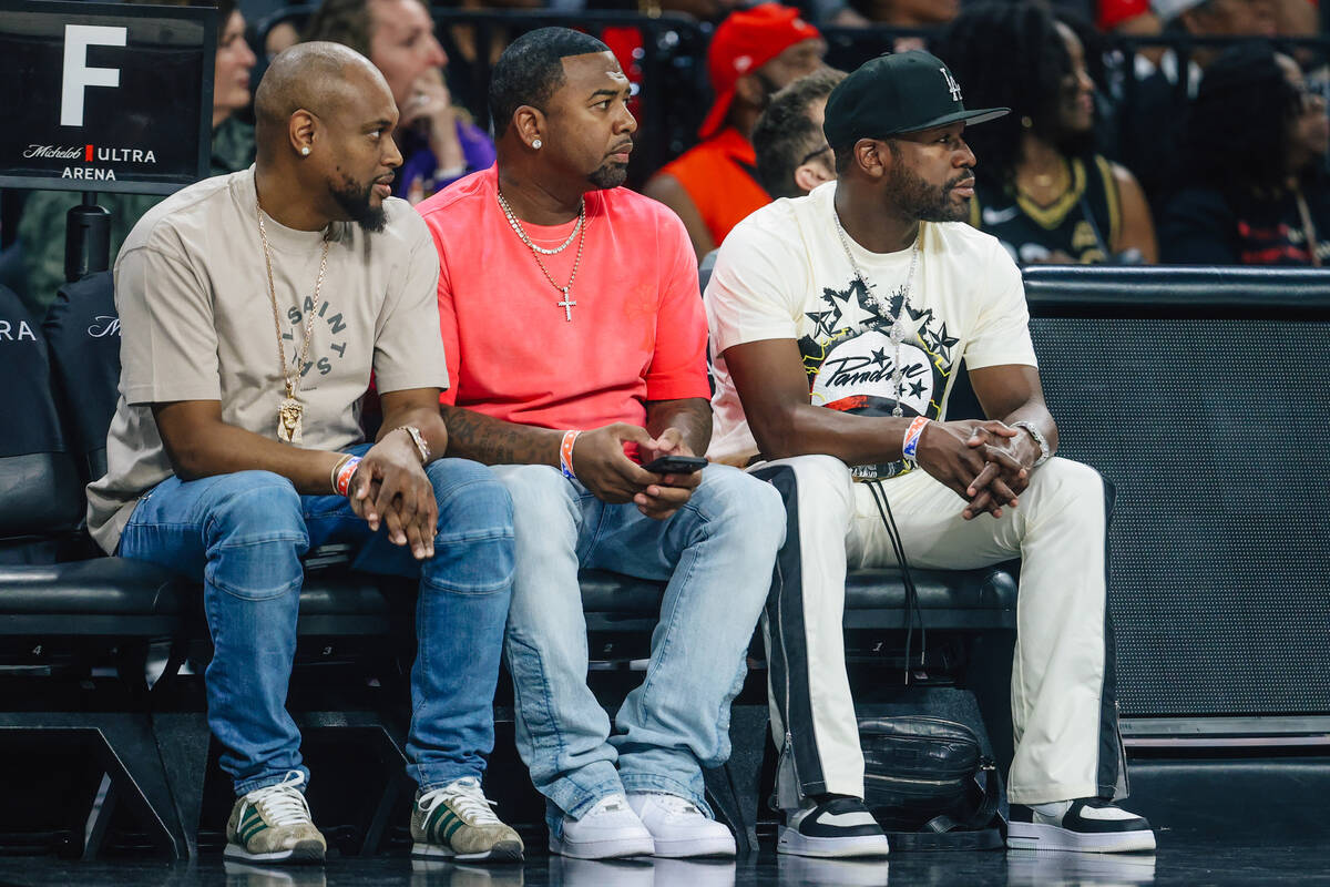 Floyd Mayweather, right, watches game action during a WNBA basketball game between the Aces and ...