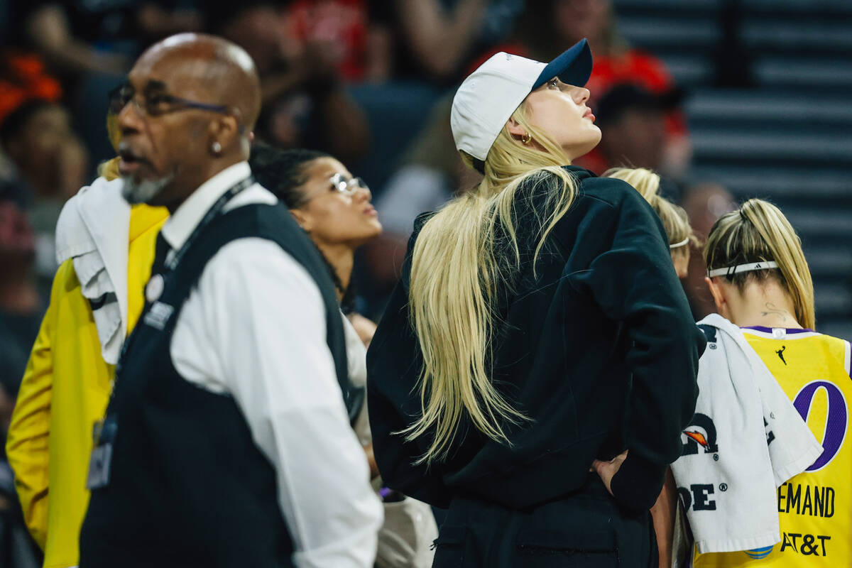 Los Angeles Sparks forward Cameron Brink, who is out with an injury, looks at the score board d ...